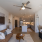 Living room with modern furniture and ceiling fan at Velo Riverside Apartments in Dayton, KY