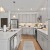 large kitchen with island and white cupboards