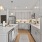 large kitchen with island and white cupboards at Velo Riverside Apartments in Dayton, KY