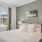 bedroom with bed and wall art at Velo Riverside Apartments in Dayton, KY