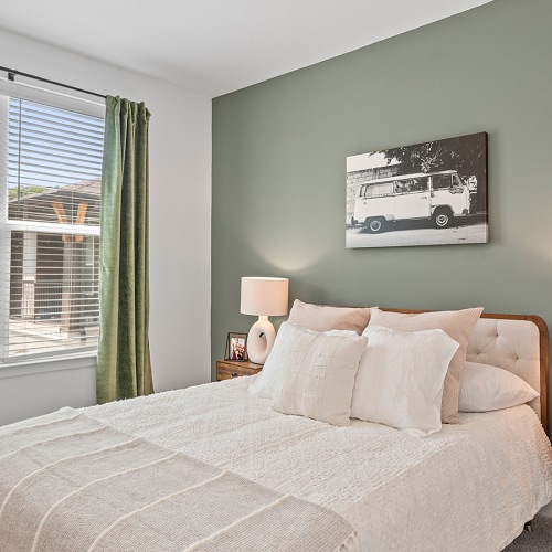 Relax and recharge in beautiful and spacious bedrooms bedroom with bed and wall art at Velo Riverside Apartments in Dayton, KY