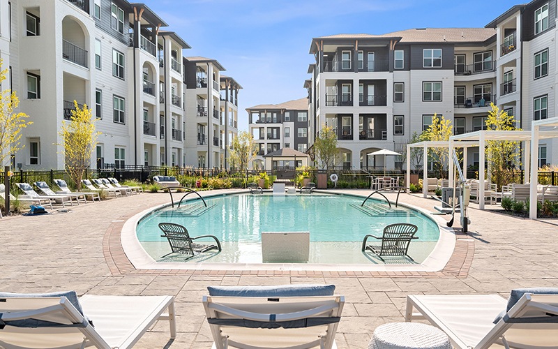 resort style pool with seating in a courtyard