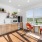 a kitchen with seating and windows at Velo Riverside Apartments in Dayton, KY