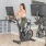 a person riding a stationary bike in a gym at Velo Riverside Apartments in Dayton, KY